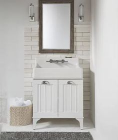 a white bathroom with a sink and mirror