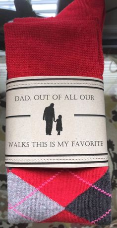 a pair of red socks with a label on it that says, dad out of all our walks this is my favorite