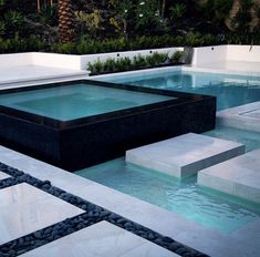 an outdoor swimming pool with steps leading up to it