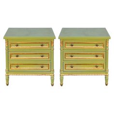 a pair of green and gold painted nightstands with drawers on each side, one drawer open