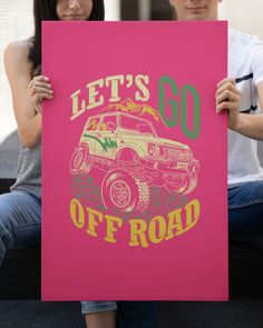 a man and woman holding up a pink sign that says let's go off road