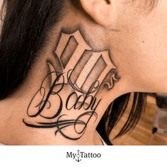 a woman's neck tattoo with the word baby written in cursive font