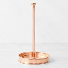 a round metal stand with a candle holder on it