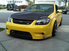 a yellow car parked in front of a house