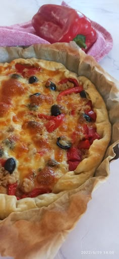 a pizza sitting on top of a pan covered in cheese and toppings