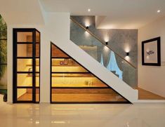 an empty room with stairs leading up to the second floor and lights on either side