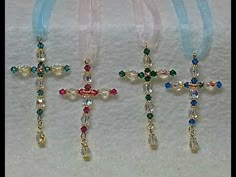 three cross necklaces with different colored beads