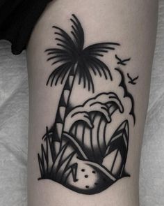 a black and white photo of a palm tree on the side of a woman's leg