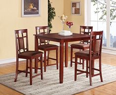 a dining room table and chairs with a rug on the floor in front of it