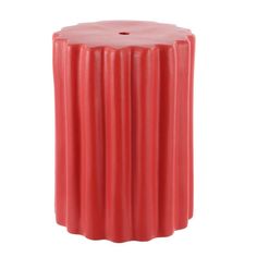 a red stool that is sitting on a white surface