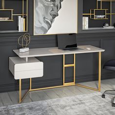 a desk with a laptop computer on top of it next to a chair and bookshelf