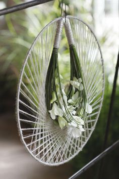 some flowers are hanging from a wire basket