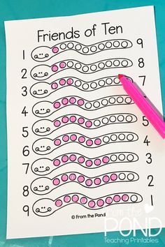 a pink pen sitting on top of a piece of paper next to a printable number line