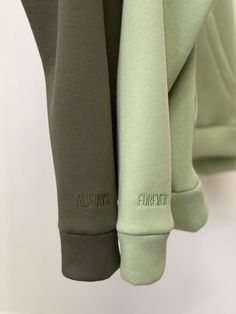 three different colored sweatpants hanging on a rack with the word always printed on them