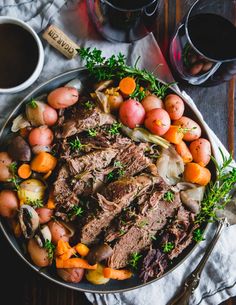 a bowl filled with meat, potatoes and carrots