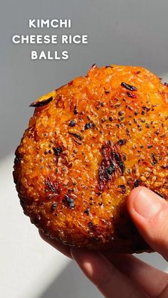 a hand holding up a piece of food with raisins on it and the words kimchi cheese rice balls above it