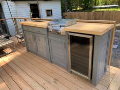 an outdoor kitchen on a wooden deck