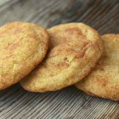 three cookies sitting on top of a wooden table