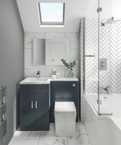 a white toilet sitting next to a sink in a bathroom under a skylight above it