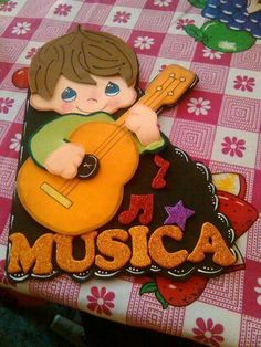 there is a cake that has a boy playing the guitar on it and says i love music