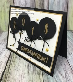 congratulations card with black balloons and gold confetti on the bottom that says congratulations