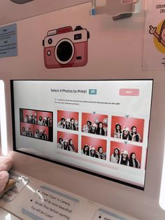 a pink polaroid camera sitting on top of a table next to a stuffed animal