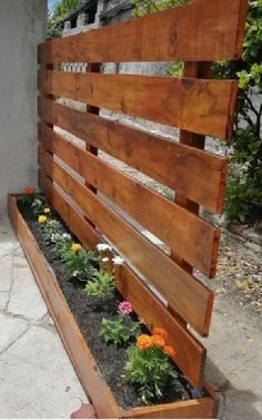 a wooden bench with flowers growing in it