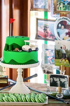 a green cake sitting on top of a table next to a plate of macaroons