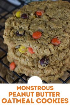 a close up of a cookie on a cooling rack with the words, monstrous peanut butter oatmeal cookies