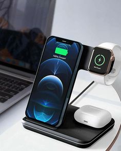 an apple watch and charging station on a desk next to a laptop with the dock attached