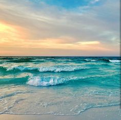 the ocean waves are rolling in and out on the beach at sunset or sunrise time