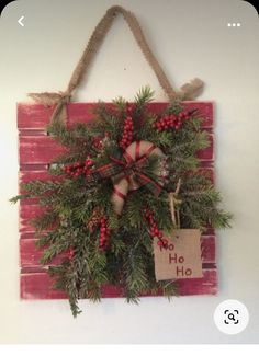 a christmas wreath hanging on the wall with a sign that says ho hoo and candy canes