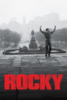 a man standing in front of a fountain with his arms up and the words rocky on it