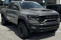 a gray truck parked in front of a building