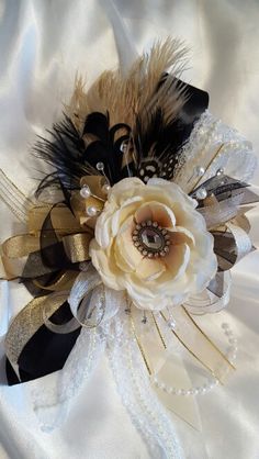 a bridal corsage with feathers and pearls