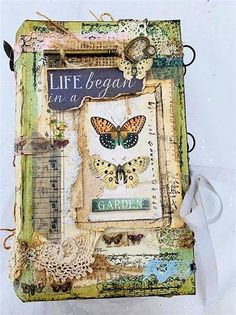 an altered photo with butterflies and words on the page that says life begins in a garden