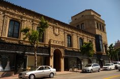 cars are parked in front of an old building