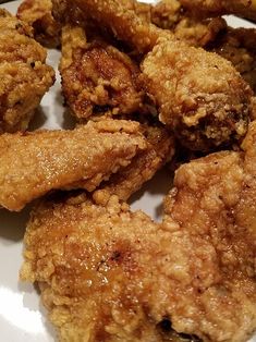 fried chicken pieces on a white plate ready to be eaten