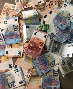 many different bills spread out on top of each other, including one hundred and twenty euros