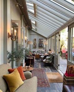 a living room filled with furniture and lots of windows