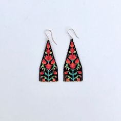 two pairs of colorful beaded earrings on white background