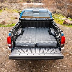 the back end of a pickup truck with its bed open