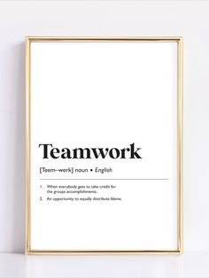 a framed poster with the words teamwork in black and white, on a wall