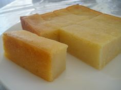 two pieces of cheese sitting on top of a white plate