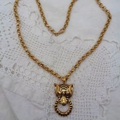 This Vintage Gold Plated Necklace / Brooch Is Signed Jackie Collins. It Features A Panther Or Tiger Doorknocker Pendant, With Black Enamel Stripes And Red Rhinestone Eyes. The Pendant / Brooch Measures 1 3/4" X 1". The Thick Necklace Chain Measures 22". It Has A Fold Down Bail For When It Is Worn As A Brooch. This Stunning Piece Is In Excellent Condition. Jackie Collins, Thick Necklace, Pendant Brooch, Rhinestone Eyes, Red Rhinestone, Gold Plated Necklace, Necklace Chain, Black Enamel, Eye Color