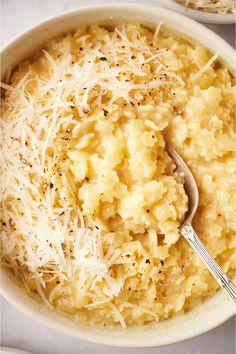 a bowl filled with macaroni and cheese topped with parmesan sprinkles