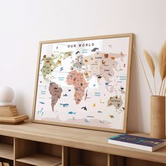 a map of the world is displayed on a shelf in front of a bookcase