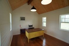 an empty room with wooden floors and white walls