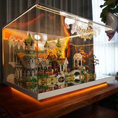 a display case with an illuminated castle in it