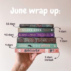 a hand holding a stack of books with the title june wrap up written above it